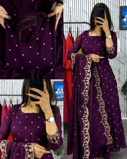 Introducing our Striking Vichitra Anarkali Adorned with Exquisite Embroidery. Paired with a delicate Border dupatta, this ensemble exudes elegance and sophistication, perfect for any special occasion - Burgundy, S