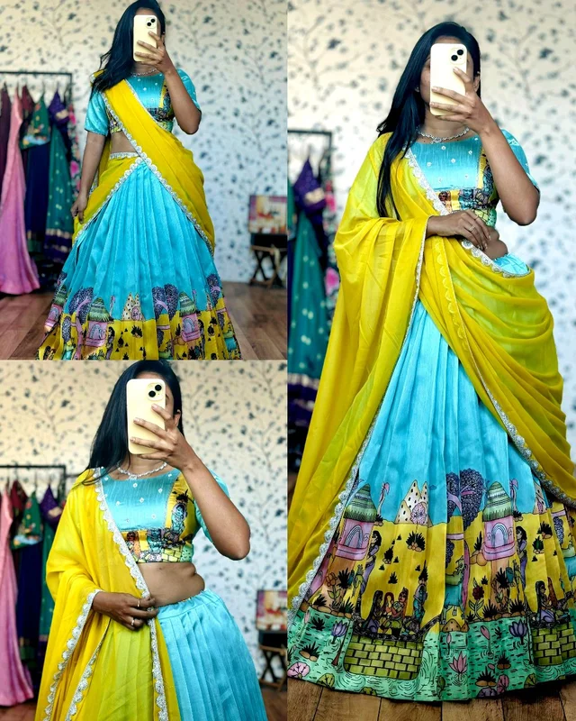Sky-blue art-inspired lehenga with a hand-painted look and a storytelling border, giving it a unique traditional charm.
Paired with a flowy yellow dupatta finished with subtle shimmer lace for an elegant festive touch ✨ - S