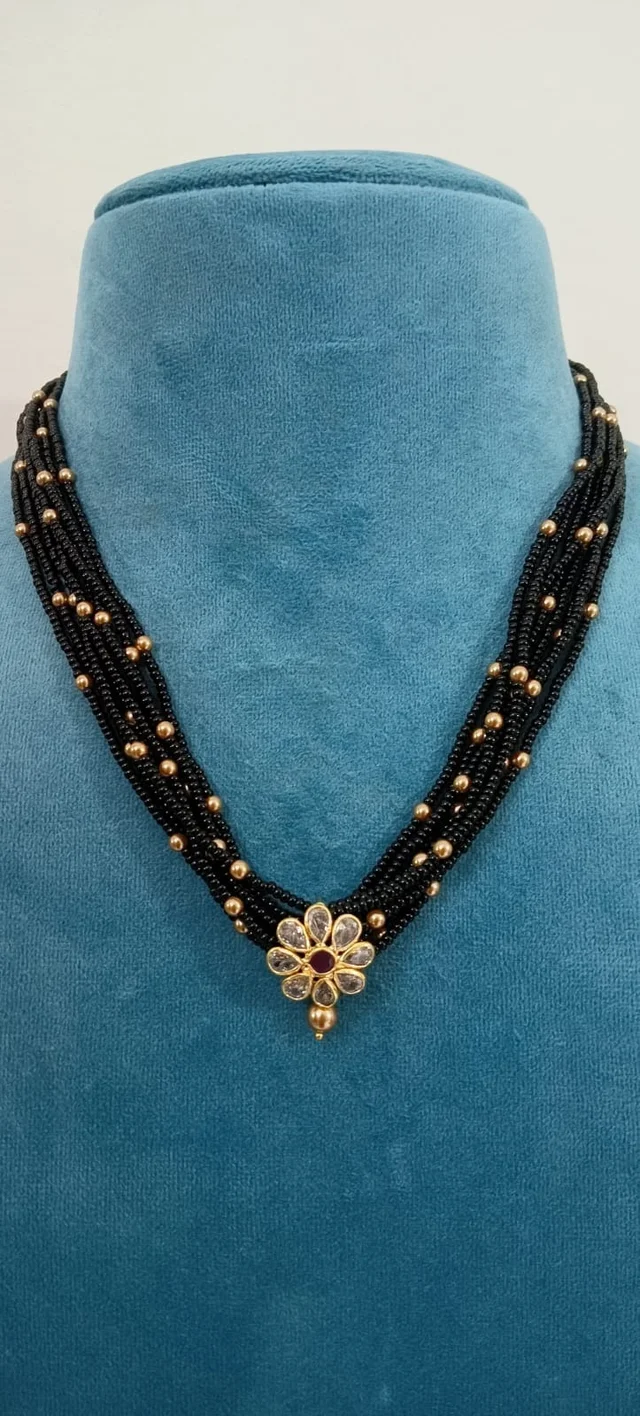 soft black beads with golden swarovski and polki pendant with red stone (11682)