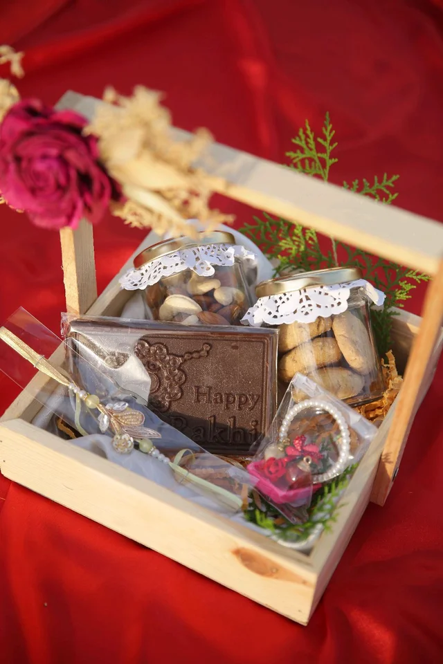 Rakhi Hamper Contains 1 Jar Of Chocolate,1 Jar Of Cookies,1 Rakhi Bar Chocolate and a Rakhi