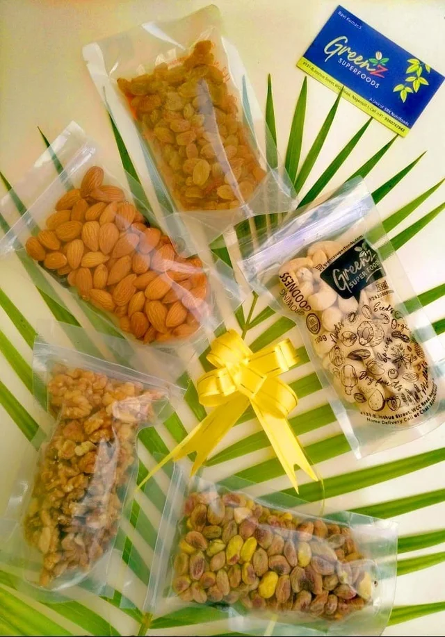 Multiple individual packs of dry fruits and nuts bundled together as a gift hamper